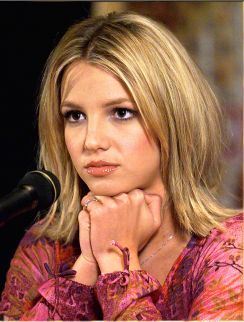 a thoughtful Britney Spears considering the nature of quantum mechanics